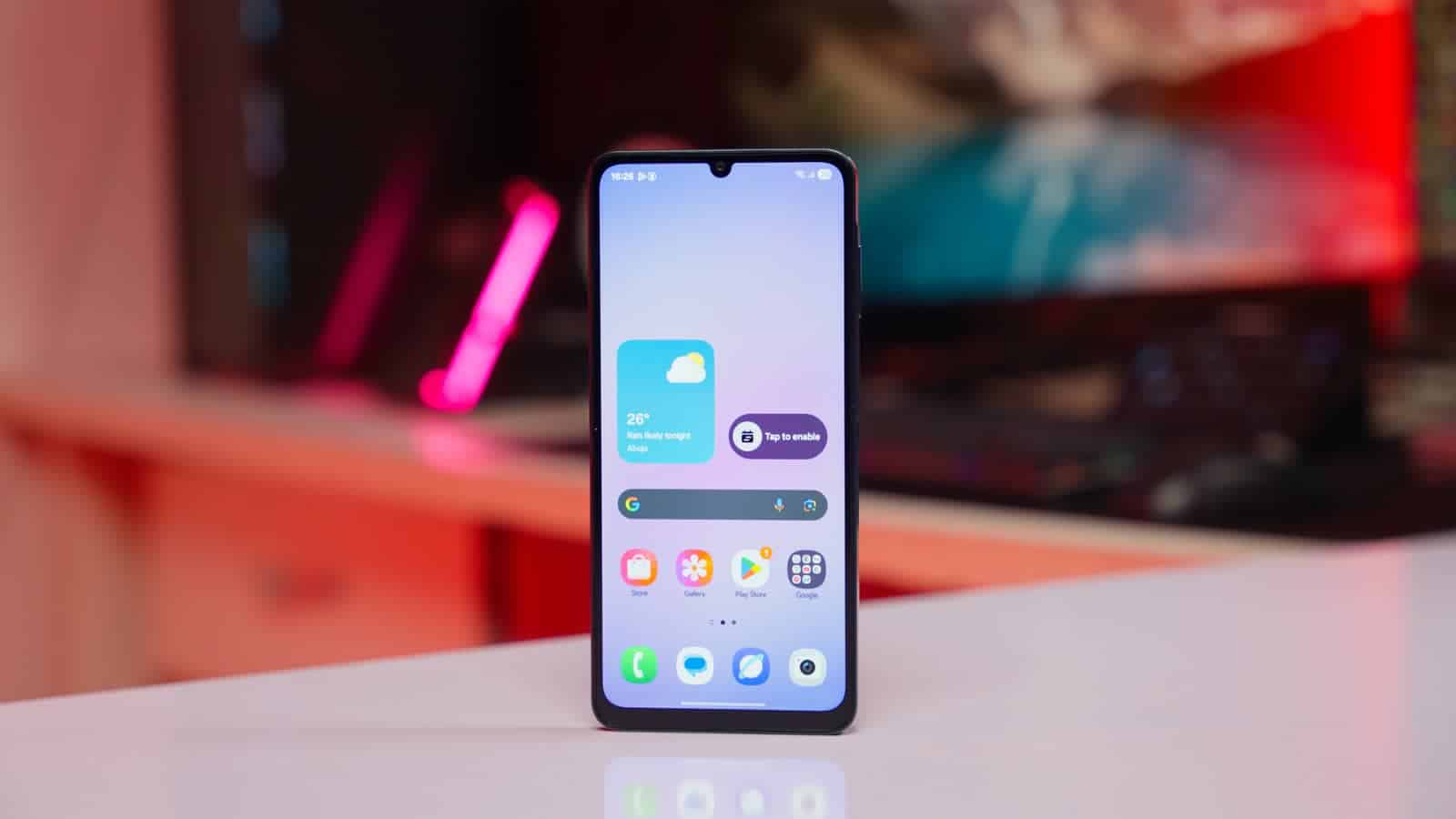 The Samsung Galaxy A07 standing on a desk, showing its home screen and waterdrop notch