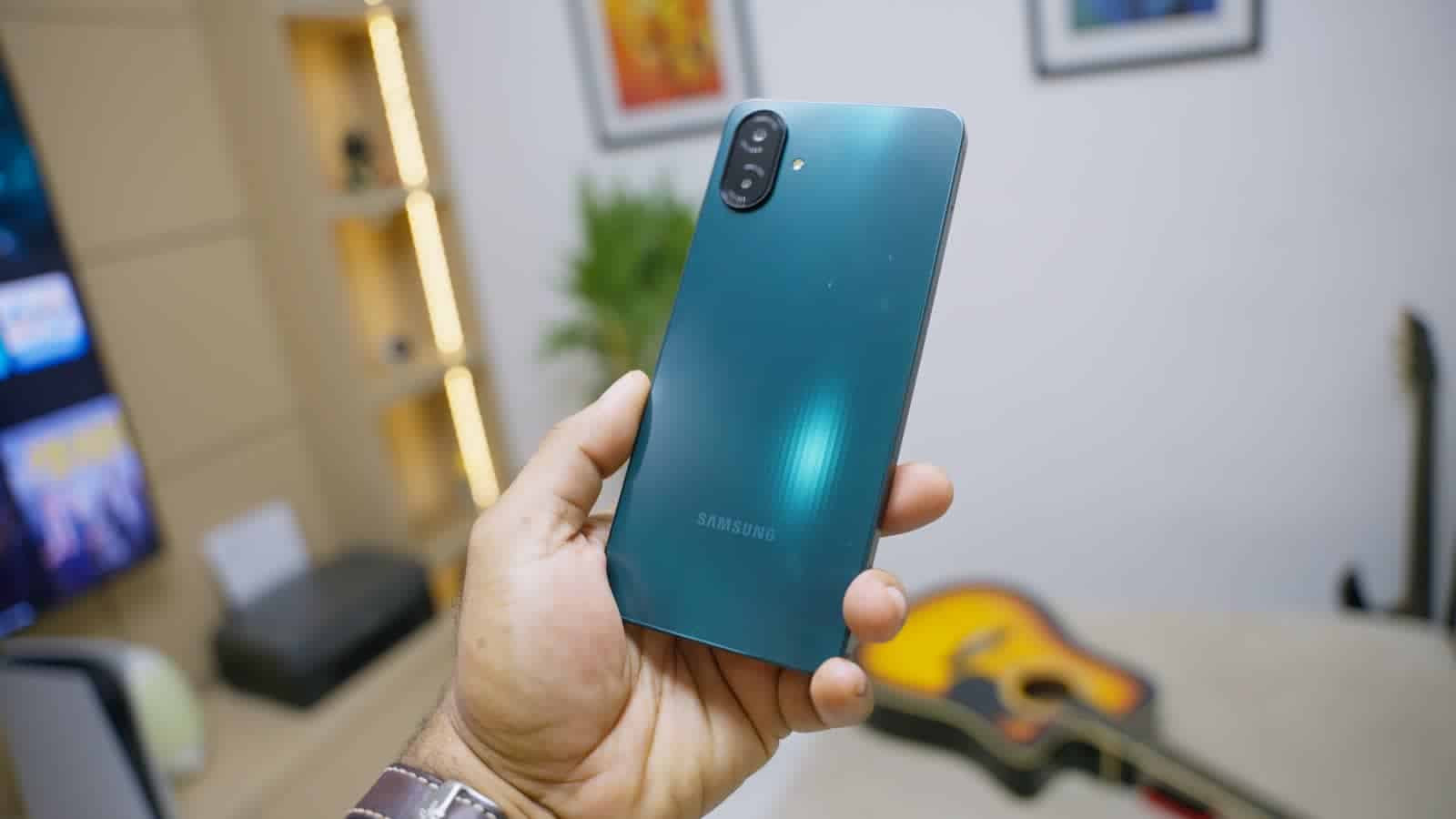 The back of the Samsung Galaxy A07 in dark green, held in one hand