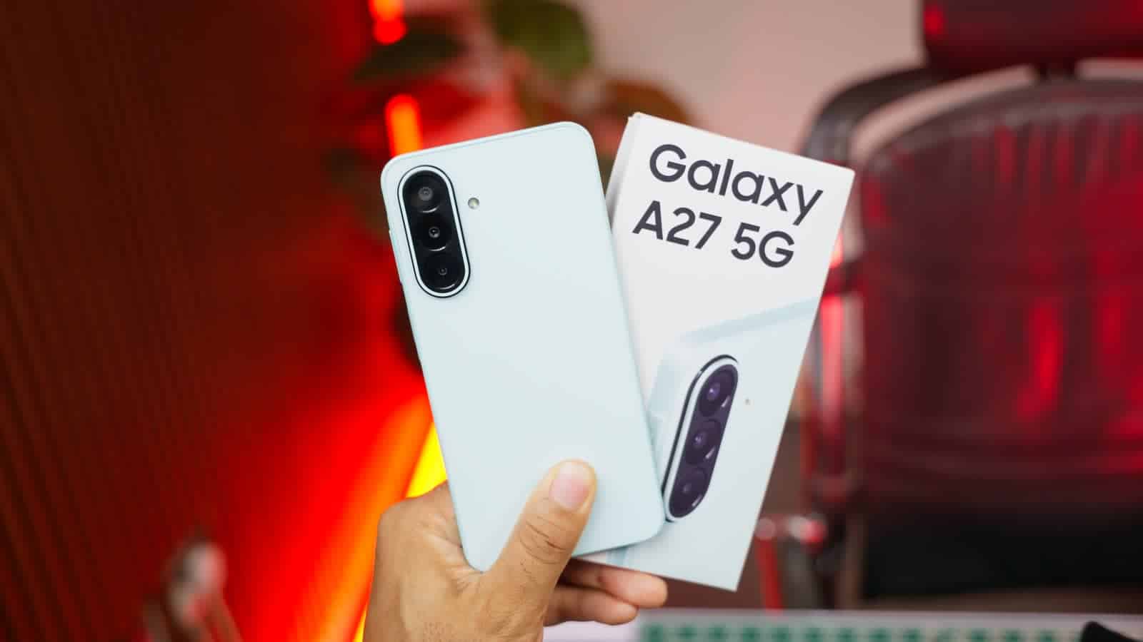 The Samsung Galaxy A27 5G in white, held beside its box