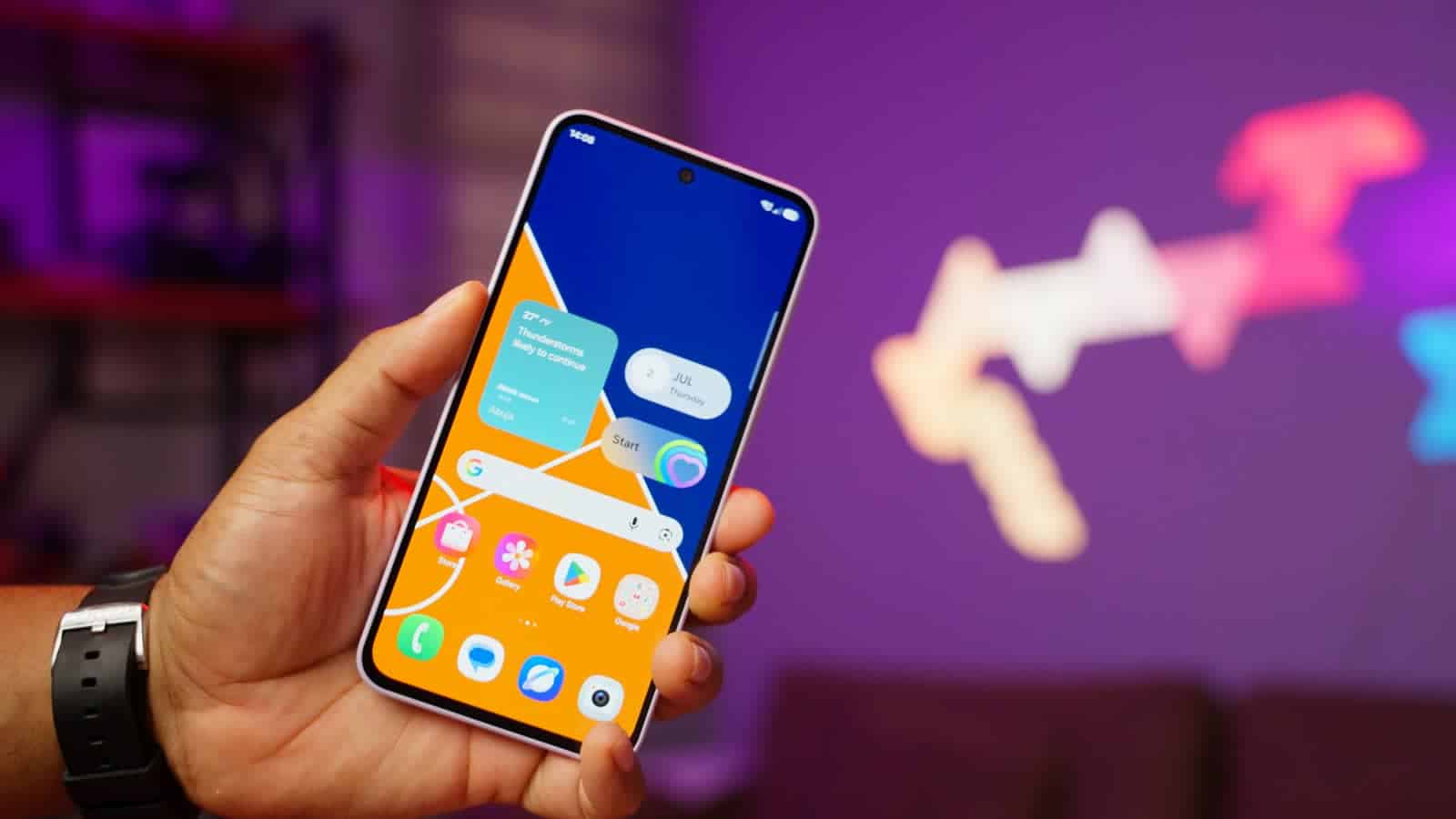 The Samsung Galaxy A37's home screen, held in one hand