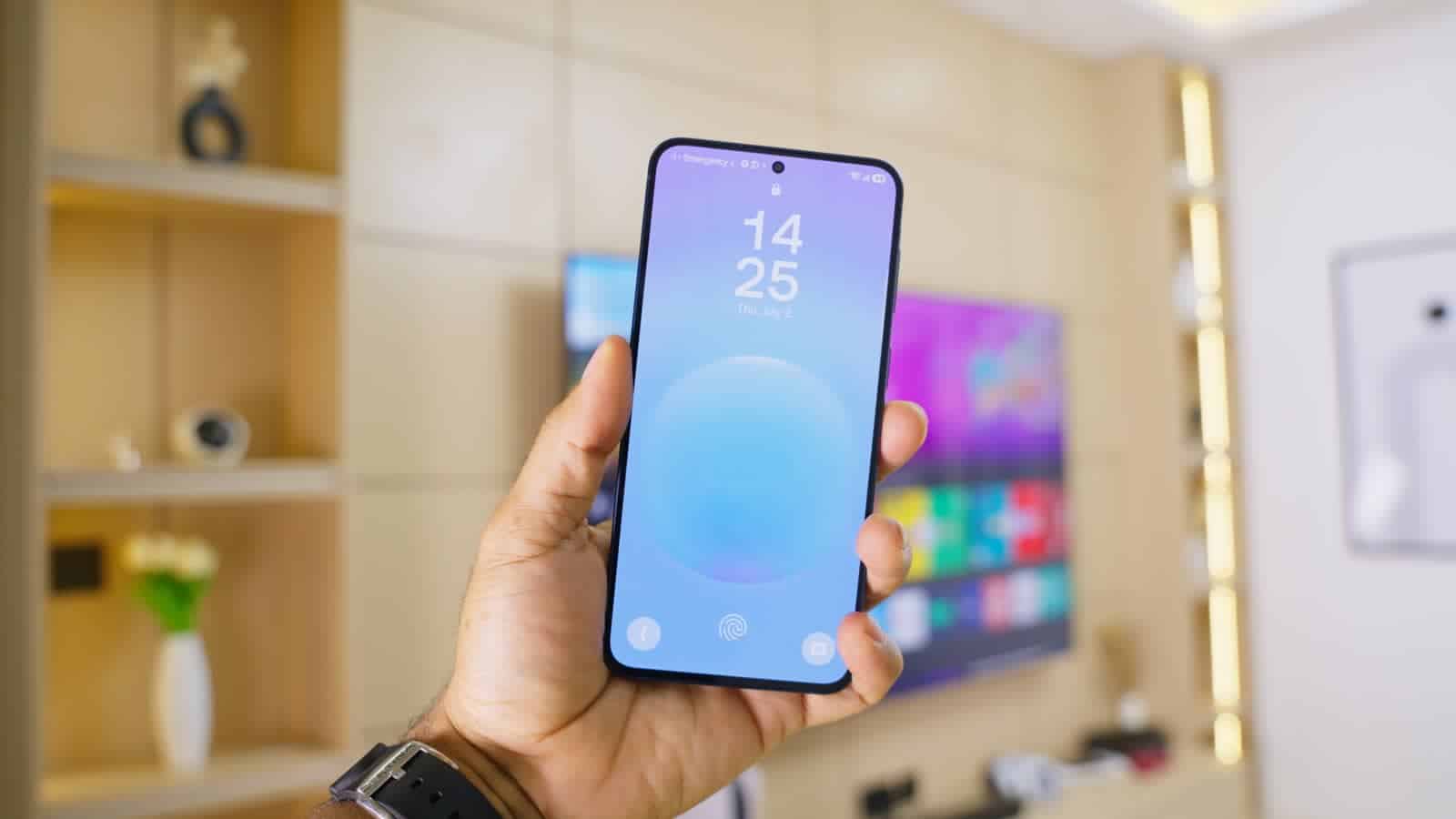 The Samsung Galaxy A57's lock screen, held in one hand
