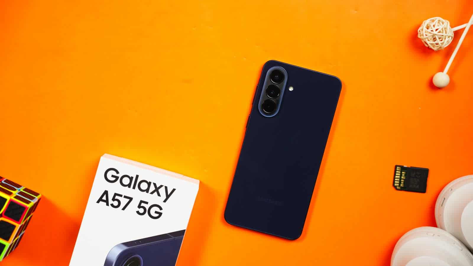 The Galaxy A57 5G in navy lying beside its box
